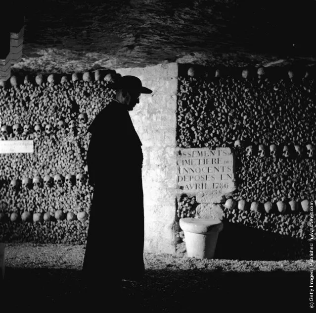 British actor Alec Guinness on location in the catacombs of Paris during filming of Father Brown