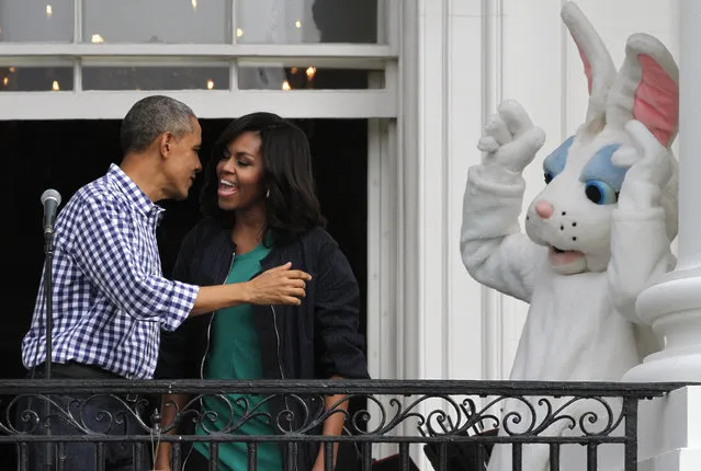 President Barack Obama turns to embrace first lady Michelle Obama, after thanking her during his remarks, as the Easter Bunny reacts, during their final White House Easter Egg Roll at the White House in Washington, Monday, March 28, 2016. Thousands of children gathered at the White House for the annual Easter Egg Roll. This year's event features  live music, sports courts, cooking stations, storytelling, and Easter egg rolling. (Photo by Jacquelyn Martin/AP Photo)