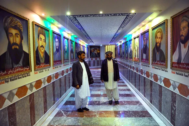 Museum staff stand among a display of portraits of prominent commanders of the Mujahedeen in the Jihad Museum, on February 15, 2014. (Photo by Aref Karimi/AFP Photo via The Atlantic)