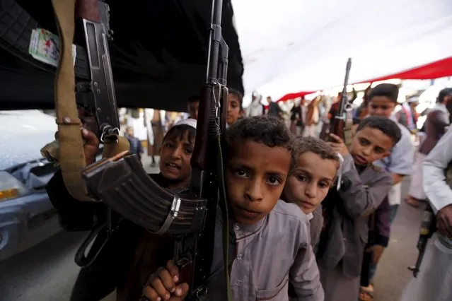 Boys hold rifles as they take part in a demonstration held by Houthi supporters against Saudi-led air strikes in Yemen's capital Sanaa March 18, 2016. (Photo by Khaled Abdullah/Reuters)