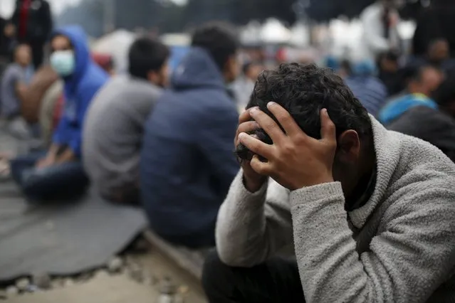 Migrants and refugees sit on a railway track at a makeshift camp at the Greek-Macedonian border near the village of Idomeni, Greece, April 3, 2016. (Photo by Marko Djurica/Reuters)