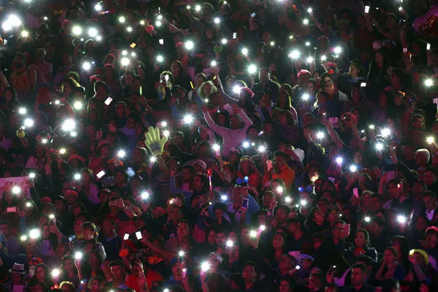 In this Wednesday, February 22, 2017 photo, fans of Spanish singer Isabel Pantoja light up the stands with their mobile phones during her performance at the Viña del Mar International Song Festival in Viña del Mar, Chile. Believed to be one of the largest musical events in Latin America, the annual five-day festival was inaugurated in 1960. (Photo by Esteban Felix/AP Photo)