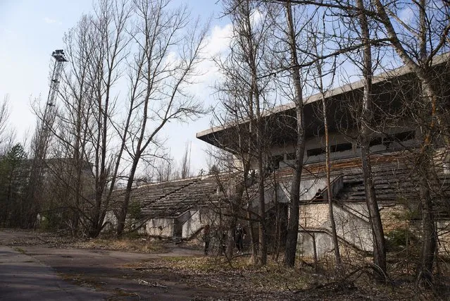 An abandoned stadium in the Pripyat, near the Chernobyl nuclear power plant in the Exclusion Zone, Ukraine, April 5, 2017. The Chernobyl nuclear accident occurred on 26 April 1986 in the No.4 light water graphite moderated reactor at the Chernobyl Nuclear Power Plant near Pripyat. An estimated 47,000 people of the city of Pripyat were evacuated after the explosion in 1986. (Photo by Vitaliy Holovin/Corbis via Getty images)