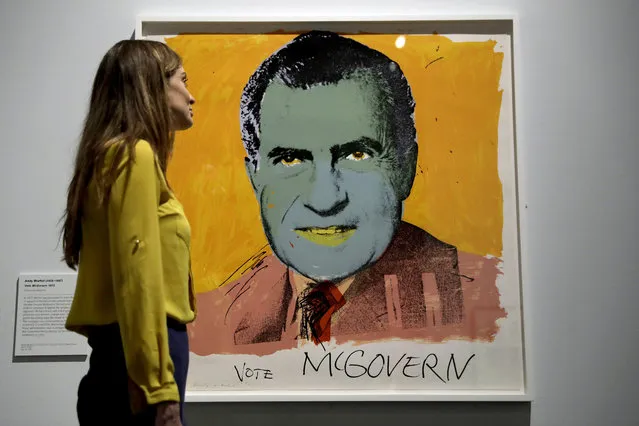 A British Museum representative poses for photographs next to “Vote McGovern” by Andy Warhol which features in “The American Dream: pop to the present” exhibition during a media photocall at the British Museum in London, Monday, March 6, 2017. (Photo by Matt Dunham/AP Photo)