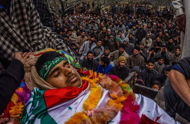 Kashmiri Muslims gather to attend the funeral ceremony of Amir Nazir, a 15 year old teenager who was killed by Indian government forces during clashes in a gun battle,  during his funeral ceremony on March 09, 2017 in Begumbagh, 30 Kilometer (18 miles) south of Srinagar, the summer capital of Indian administered Kashmir, India. Two civilians including a teenager boy were killed in clashes with Indian government forces when they tried to save the local rebels who were engaged in a gun battle with forces the rebels were also killed in the gun battle later in the day, in the Pulwom district of south Kashmir. (Photo by Yawar Nazir/Getty Images)