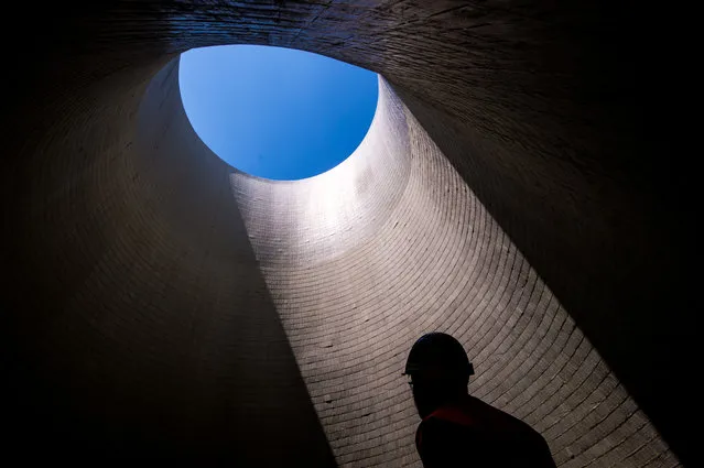 An employee stands inside the cooling tower of the third and fourth unit still under construction at Mochovce nuclear power plant, western Slovakia, on July 2, 2019. Top Slovak power producer Slovenske Elektrarne (SE) operates the nuclear power plant in Mochovce. Launching of the two new units has been a cause for concern in neighbouring Austria, which has repeatedly criticised what it insists are their poor safety standards. (Photo by Vladimir Simicek/AFP Photo)