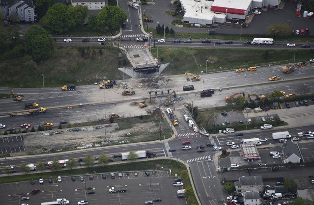 This aerial view looking east shows demolition crews working to finish removing the Fairfield Avenue bridge over Interstate 95, Saturday, May 4, 2024 in Norwalk, Conn. Crews are expected to finish removing the bridge by Sunday morning, and road repairs will be made. The tanker truck burst into flames under the overpass after colliding with two other vehicles Thursday. The cause remains under investigation. (Photo by Kevin Coughlin/All Island Aerial via AP Photo)