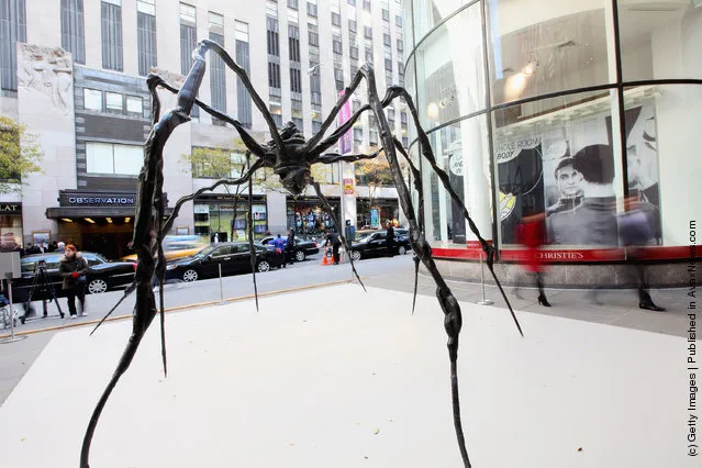 Spider-Man: Turn Off the Dark actor Craig Henningsen walks beneath the 21-foot wide 'Spider' sculpture by artist Louise Bourgeois