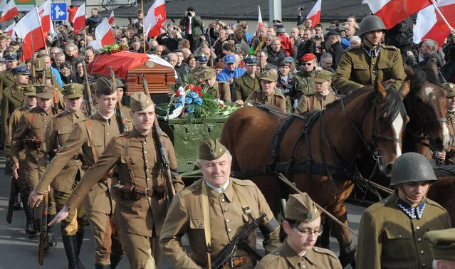 The coffin with the remains of Zygmunt Szendzielarz is driven on a horse carriage during his funeral in Warsaw, Poland, Sunday, April 24, 2016. Polish President Andrzej Duda and government ministers have taken part in the state burial of Szendzielarz, a World War II resistance commander and communist regime victim whose remains were found in a hidden mass grave. (Photo by Alik Keplicz/AP Photo)