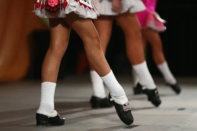 Competitors perform at the World Irish Dance Championship on April 13, 2014 in London, England. The 44th World Irish Dance Championship is currently running at London's Hilton London Metropole hotel, and will host approximately 5,000 dancers competing in solo, Ceili, modern figure choreography and dance drama categories during the week long event. (Photo by Dan Kitwood/Getty Images)