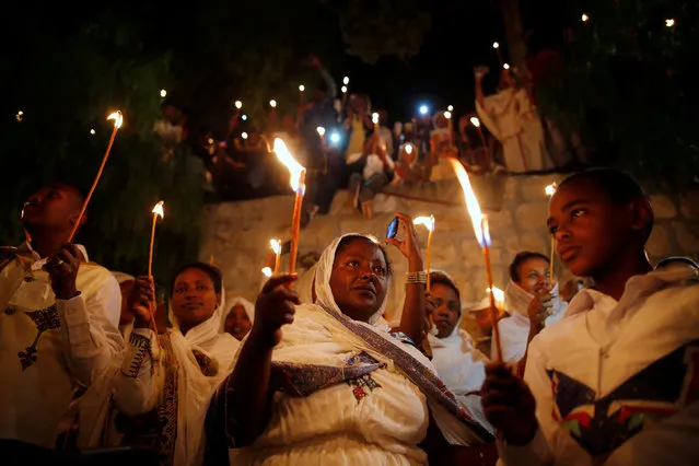 Ethiopian Orthodox worshippers hold candles during the Holy Fire ceremony at the Ethiopian section of the Church of the Holy Sepulchre in Jerusalem's Old City April 30, 2016. (Photo by Amir Cohen/Reuters)
