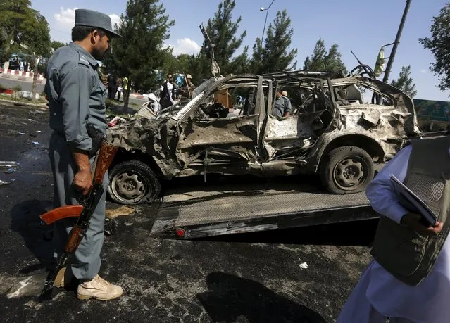 An Afghan policeman inspects the site of a suicide bomb attack in Kabul, Afghanistan, June 30, 2015. (Photo by Omar Sobhani/Reuters)