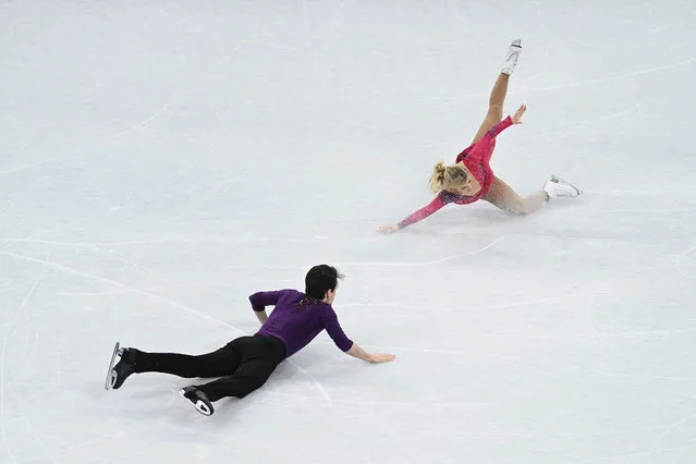 Kirsten Moore-Towers and Michael Marinaro of Team Canada fall during the Pair Skating Short Program on day fourteen of the Beijing 2022 Winter Olympic Games at Capital Indoor Stadium on February 18, 2022 in Beijing, China. (Photo by David Ramos/Getty Images)
