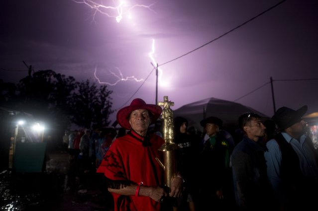 Julio Rivero holds a figure of Argentina's folk Saint “Gauchito” Gil at his sanctuary in Mercedes, Corrientes, Argentina, Sunday, January 7, 2024. Every Jan. 8, devotees from across the country visit his sanctuary to ask for miracles or give him thanks. (Photo by Natacha Pisarenko/AP Photo)