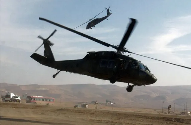 Sikorsky UH-60 Black Hawk helicopters fly near the U.S. military base in Mosul, north of Baghdad in a January 4, 2006 file photo. Lockheed Martin Corp said Monday it would buy Sikorsky Aircraft, the helicopter unit of United Technologies Corp, for $9 billion, and would review the possible sale or spinoff of $6 billion in other information technology and services businesses. (Photo by Namir Noor-Eldeen/Reuters)
