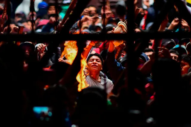 Prisoners are seen at the San Pedro prison during a riot demanding the resignation of prisons' director Ernesto Vergara in La Paz on November 12, 2019. Bolivia's Evo Morales was en route to exile in Mexico on Tuesday, leaving behind a country in turmoil after his abrupt resignation as president. The senator set to succeed Morales as interim president, Jeanine Anez, pledged to call fresh elections to end the political crisis. (Photo by Ronaldo Schemidt/AFP Photo)
