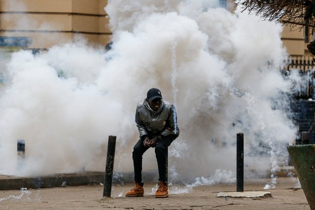 A pro-reform protester reacts to tear gas fired by police during an anti-government demonstration over what organisers say are tax hikes, bad governance, constitutional violations, extra-judicial killings and cost of living, in Nairobi, Kenya, on August 8, 2024. (Photo by Thomas Mukoya/Reuters)