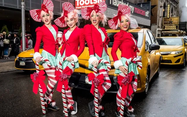 Revellers gather for the start of the Annual SantaCon Bar Crawl at Father Duffy Square, a section of Times Square, on December 14, 2019, in New York City. SantCon is an event where people make donations to charitable causes and dress up as a Christmas character and visit bars around the city. (Photo by Steven Ferdman/Getty Images)