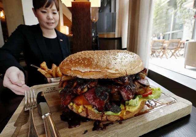 In this Thursday, March 28, 2019, photo, a “golden giant burger” is served at a restaurant of Hotel Grand Hyatt Tokyo in Tokyo. The $900 wagyu (Japanese-produced beef) burger was unveiled to commemorate the era change. What’s in a name? Quite a lot if you’re a Japanese citizen awaiting the official announcement Monday, April 1, 2019 of what the soon-to-be-installed new emperor’s next era will be called. It’s a proclamation that has happened only twice in nearly a century, and the new name will follow Emperor Naruhito, after his May 1 investiture, for the duration of his rule, attaching itself to much of what happens in Japan. (Photo by Kyodo News via AP Photo)