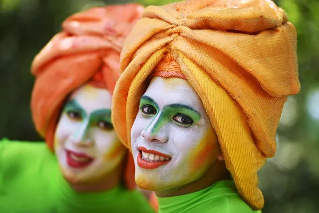 Two men in costume participate in the parade that initiates the festivities of the Divine Savior of the World, in San Salvador, on August 1, 2015. (Photo by Marvin Recinos/AFP Photo)