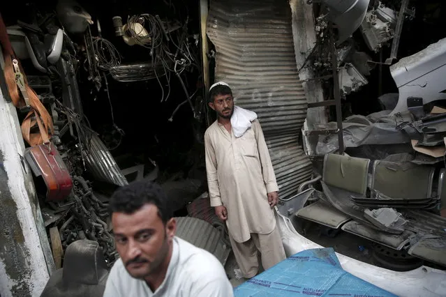 Afghan men stand next to damaged shops near the site of a truck bomb blast in Kabul, Afghanistan August 7, 2015. An official at the Emergency Hospital in Kabul said it had been flooded with almost 100 patients, including many women and children, seeking treatment for minor wounds caused by debris. (Photo by Ahmad Masood/Reuters)