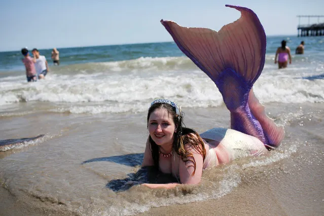 A participant dressed as a mermaid goes to swim in the beach after taking part in the Annual Mermaid Parade in Brooklyn, New York, June 18, 2016. (Photo by Eduardo Munoz/Reuters)