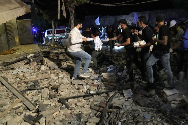 People collecting remains of victims after an airstrike that hit an apartment in Beirut, Lebanon, Thursday, October 3, 2024. (Photo by Hussein Malla/AP Photo)