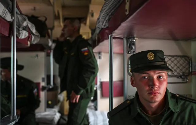 A conscript, wearing a military uniform, looks on inside a train carriage at a local railway station during departure for the garrisons, in Omsk, Russia on June 17, 2022. (Photo by Alexey Malgavko/Reuters)