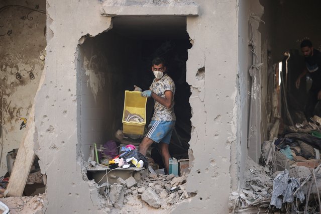 Relatives of Ahmed Al-Khatib clean rubble in their damaged apartment at the strike site in Beirut, Lebanon, on October 11, 2024. (Photo by Louisa Gouliamaki/Reuters)