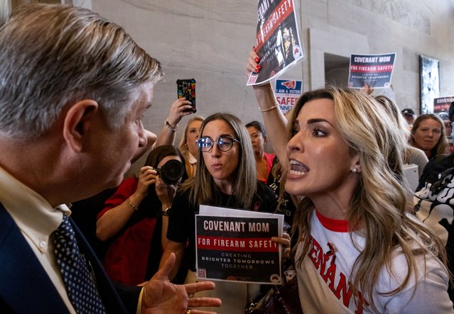 A man argues with Mary Joyce, a Covenant School mother, after the Tennessee House Republicans called for a vote to end special session on public safety to discuss gun violence in the wake of the Covenant School shooting in Nashville, Tennessee, U.S., August 29, 2023. (Photo by Seth Herald/Reuters)