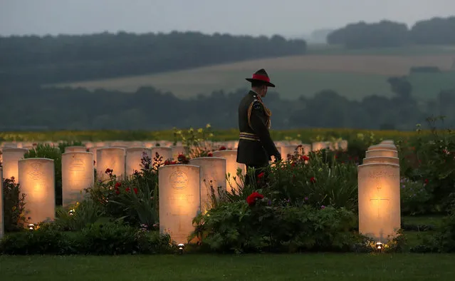 A member of Military personnel  looks a war graves during part of a military-led vigil to commemorate the 100th anniversary of the beginning of the Battle of the Somme at the Thiepval memorial to the Missing on June 30, 2016 in Thiepval, France. The event is part of the Commemoration of the Centenary of the Battle of the Somme at the Commonwealth War Graves Commission Thiepval Memorial in Thiepval, France, where 70,000 British and Commonwealth soldiers with no known grave are commemorated. (Photo by Steve Parsons/Getty Images)