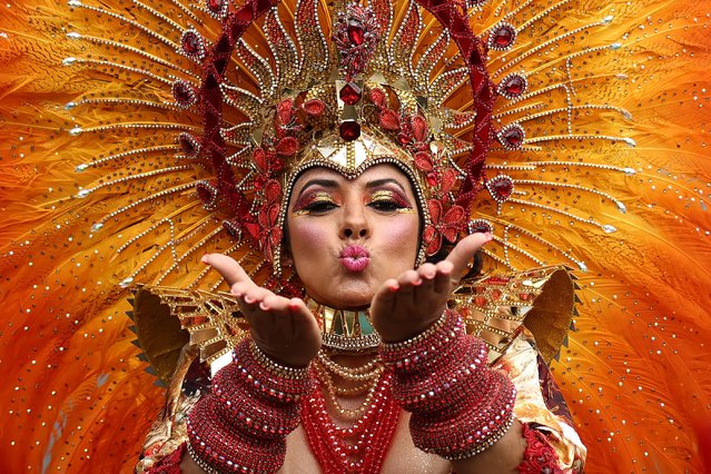 A performer in costume blows a kiss during the main parade of the Notting Hill Carnival in west London on August 27, 2023. (Photo by Henry Nicholls/AFP Photo)