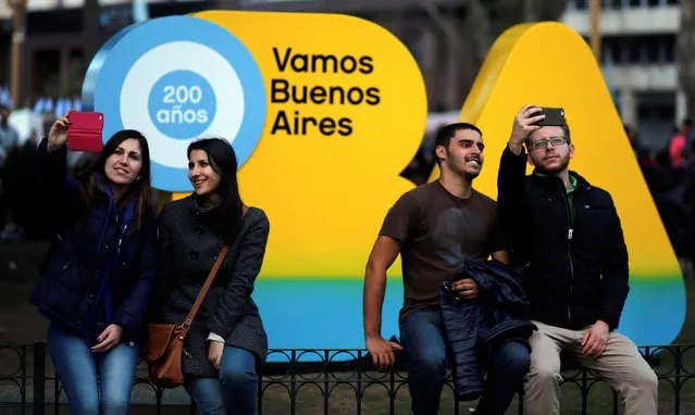 People take selfies in front of the Buenos Aires logo at Plaza de Mayo square during celebrations of the bicentennial anniversary of Argentina's independence from Spain in Buenos Aires, Argentina, July 9, 2016. (Photo by Marcos Brindicci/Reuters)