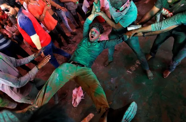Men daubed in colours take part in “Lathmar Holi” celebrations inside a temple in the town of Barsana, in the northern state of Uttar Pradesh, India, March 4, 2020. (Photo by Adnan Abidi/Reuters)