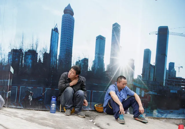 Workers rest outside a construction site in Beijing's central business district, China, July 15, 2016. (Photo by Jason Lee/Reuters)