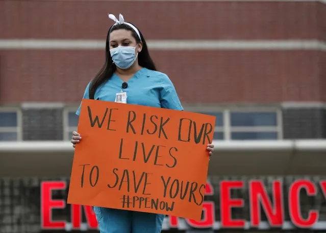 A nurse demonstrates outside the emergency entrance at Jacobi Medical Center in the Bronx borough of New York, Saturday, March 28, 2020, demanding more personal protective equipment for medical staff treating coronavirus patients. A member of the New York nursing community died earlier this week while treating coronavirus patients at another New York hospital. The city leads the nation in the number of COVID-19 cases, and the United States currently has the most cases in the world, according to the World Health Organization. (Photo by Kathy Willens/AP Photo)