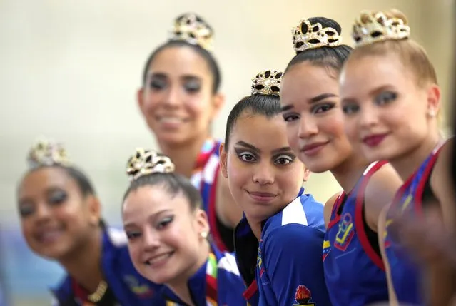 Venezuela's team wait before their performance in the rhythmic gymnastics event during the Bolivarian Games in Valledupar, Colombia, Sunday, July 3, 2022. (Photo by Fernando Vergara/AP Photo)