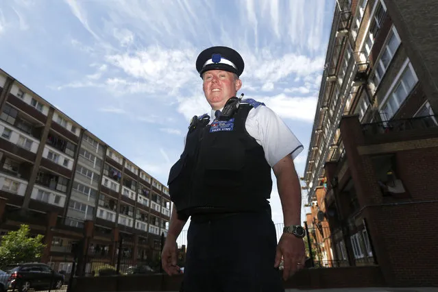 Police Community Support Officer (PCSO) Peter Austridge of the Enfield Borough Police poses whilst on patrol on the Shires Estate in Edmonton, north London, July 16, 2014. (Photo by Luke MacGregor/Reuters)