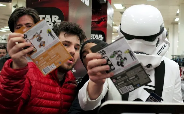 A shopper wearing an Imperial Stormtrooper helmet collects new toys from the upcoming film “Star Wars: The Force Awakens” just after midnight on “Force Friday” in Sydney, September 4, 2015. (Photo by Jason Reed/Reuters)