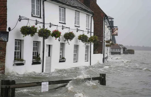 Sea water floods the shore line after high tide in Langstone, south England, Tuesday December 7, 2021, with disruptive winds, heavy rain and snow was forecast. (Photo by Andrew Matthews/PA Wire via AP Photo)