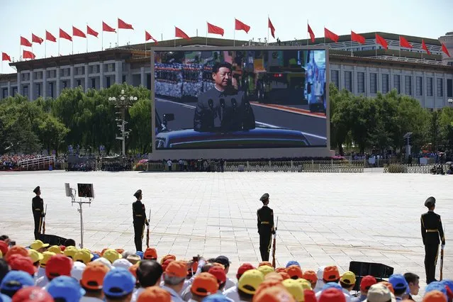 Chinese President Xi Jinping is shown on a big screen at Tiananmen Square as he reviews troops at the beginning of the military parade marking the 70th anniversary of the end of World War Two, in Beijing, China, September 3, 2015. (Photo by Damir Sagolj/Reuters)
