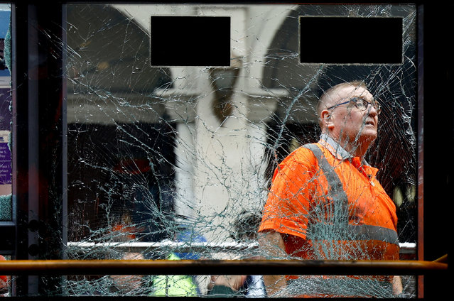 A worker inspects a damaged tram, following a riot in the aftermath of a school stabbing that left several children and adults injured, in Dublin, Ireland on November 24, 2023. (Photo by Clodagh Kilcoyne/Reuters)