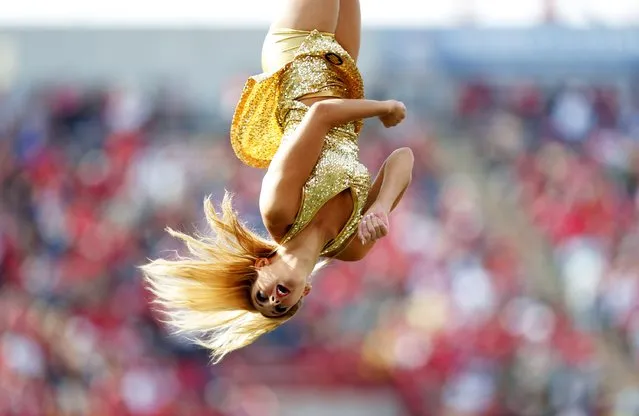 A cheerleader for the Edmonton Eskimos goes flying through the air while they played the Calgary Stampeders during their CFL football game September 1, 2014 at McMahon Stadium in Calgary, Alberta, Canada. (Photo by Todd Korol/Getty Images)