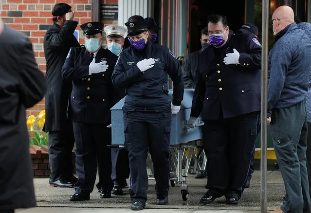 Members of the New York City paramedic community escort the casket of their colleague as they attend a funeral for New York City paramedic Anthony “Tony” Thomas during the outbreak of coronavirus disease (COVID-19) in the Bay Ridge area of Brooklyn, New York, U.S., April 30, 2020. (Photo by Brendan McDermid/Reuters)