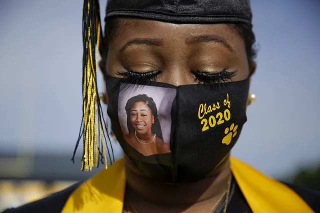 Graduating senior Yasmine Protho, 18, wears a photo of herself and Class of 2020 on her protective mask amid the coronavirus pandemic as she graduates with only 9 other classmates at a time with limited family attending at Chattahoochee County High School on Friday, May 15, 2020, in Cusseta, Ga. (Photo by Brynn Anderson/AP Photo)