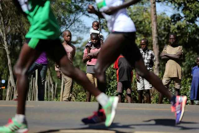 Athletes run on a road during a half marathon near the town of Eldoret in western Kenya, March 20, 2016. (Photo by Siegfried Modola/Reuters)