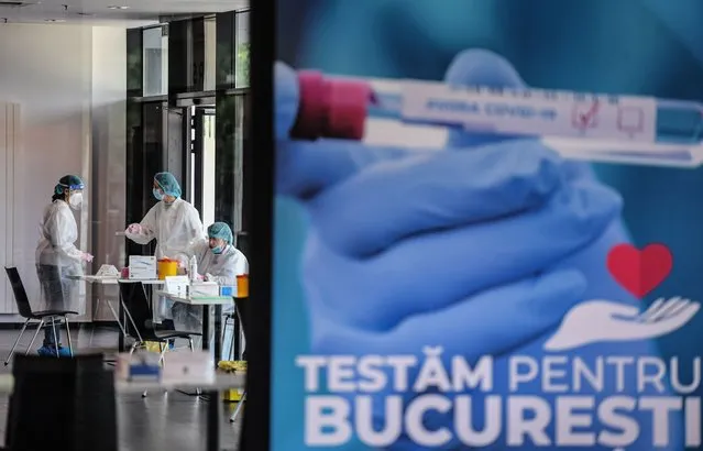 Medical personnel prepare to test people for Coronavirus at National Arena stadium in Bucharest June 10, 2020. A testing programme called “Am I immune to COVID?” begins on Tuesday, at the National Arena stadium where the City Hall of Bucharest has made all the necessary preparations from a medical and logistical point of view to randomly test around 2,000 people. The first 500 people from Bucharest are being tested starting from Tuesday for Covid antibodies. So far, we 2,000 people registered. The program was launch to see, on a scientific basis, how many people have already been affected, given that extended testing is the only way to do this. (Photo by Daniel Mihailescu/AFP Photo)