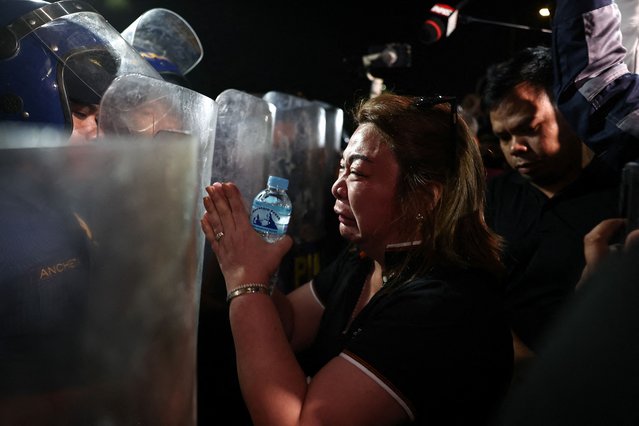 A supporter of former Philippine President Rodrigo Duterte pleads with members of the Philippine National Police standing guard outside the Villamor Airbase where Duterte is currently held after being arrested, in Pasay City, Metro Manila, Philippines on March 11, 2025. (Photo by Eloisa Lopez/Reuters)