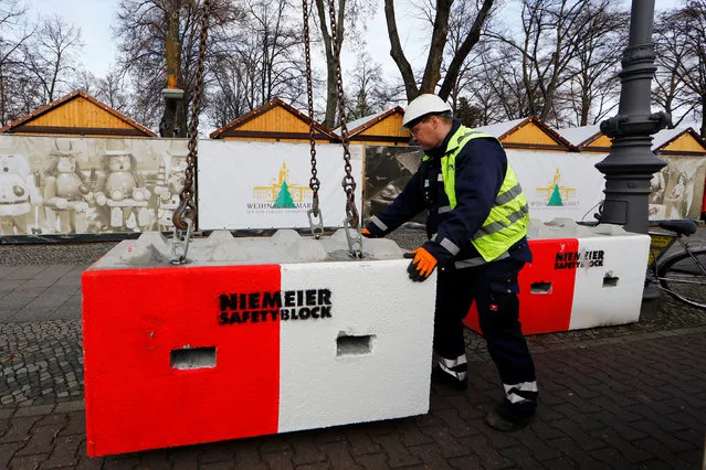 A worker installs concrete barriers at the Christmas Market at Schloss Charlottenburg in Berlin, Germany November 27, 2017. (Photo by Axel Schmidt/Reuters)