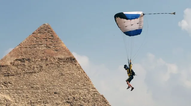 A skydiver flies over the Great Pyramids during the fifth edition of the Egypt Air Sport Festival in Giza, Egypt, 02 November 2022. Dozens of international athletes participated in the fifth edition of the Air Sports Festival. (Photo by Khaled Elfiqi/EPA/EFE/Rex Features/Shutterstock)